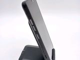 a cell phone that is sitting on top of a stand