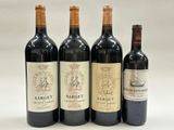 three bottles of red wine are lined up on a white surface