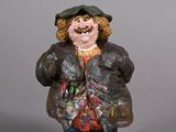 a figurine of a man wearing a hat and jacket