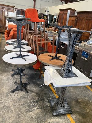 many tables and chairs in a room with a lot of furniture