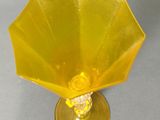 an image of a yellow vase with a flower inside of it