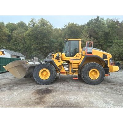a picture of a yellow wheel loader parked in a parking lot