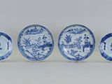 quatre assiettes bleues et blanches ornées de fleurs et d'oiseaux