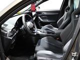 the interior of a car with the door open and the driver ' s seat down
