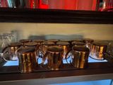 a lot of cups that are sitting on a shelf
