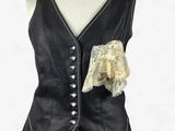 black leather dress with white trimmings and a gold broochet