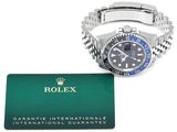 a rolex watch and a credit card on a white background