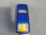 a blue toy car sitting on the floor next to a box of toys