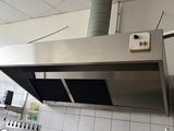 a kitchen with a stove, oven, and sink in it