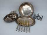 a silver plate with spoons and forks in it