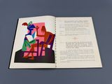 un livre ouvert sur lequel figure l'image d'un homme et d'une femme assis sur une chaise
