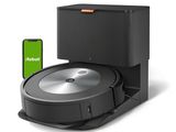 a black robot vacuum with a green screen next to it