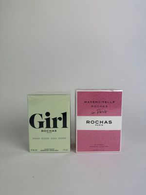 two boxes of perfume sitting next to each other on a white surface