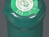 a close up of a bottle of wine with a green cap