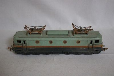 a green and black train car sitting on a white surface