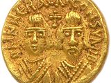 a close up of a gold coin on a white surface
