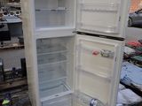 a white refrigerator that is sitting on a pallet in a warehouse