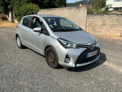 the car is parked on the side of the road next to a wall