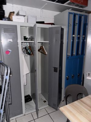 two lockers in a room with a table and chairs