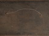 an old suitcase with a handle sitting on top of a wooden floor