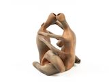 figurine of a man and woman sitting on a white surface