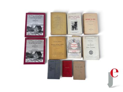 several old books sitting on top of each other on a white surface
