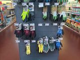 a display of gardening gloves and gardening gloves in a store