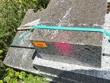 a cement block with a green ribbon on it