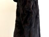 a fur coat hanging on a wall in a room