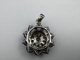 a close up of a silver pendant with an eye inside of it