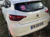 a white car that is parked in front of a fence