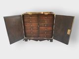 an image of a wooden chest of drawers with two doors open