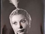black and white photograph of a woman with a feather on her head