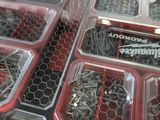 a lot of screws in the trays on the table