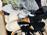 many pairs of shoes in a box on the floor
