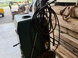a machine that is sitting on the floor next to a pile of wood