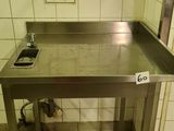 a metal table with a drain in the middle of it