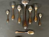 a lot of spoons and forks on the table