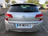 the back of a silver citrole parked in a parking lot