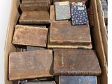 a box full of old books sitting on a table