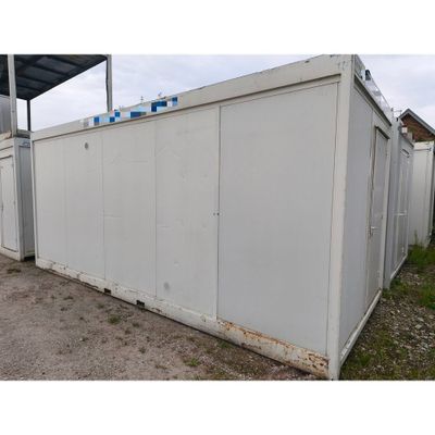 an image of a white storage container sitting in the dirt