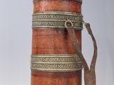 a small wooden box with a strap on it