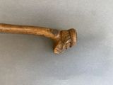 a wooden stick with a head on it on a table