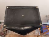 a black bag that is sitting on top of a chair