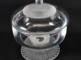 a clear glass bowl with a lid on a black surface