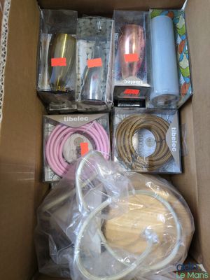 a cardboard box filled with assorted electronics and other items