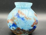 a blue vase that is sitting on a table