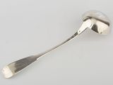 silver spoon on a white surface with a spoon in the middle of it