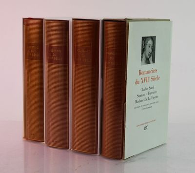 three books sitting on top of a white table next to each other