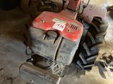 a small machine that is sitting in a garage
